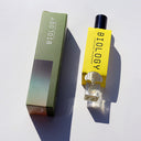 Biology Balance Rollerball Perfume and box shown from an angled top-down view
