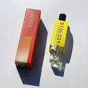 Biology Deep Rollerball Perfume and box shown from an angled top-down view