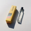 Biology Joy Rollerball Perfume and box laid flat on white background